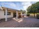 Cozy backyard with covered patio, hot tub, and low-maintenance desert landscaping at 3956 N 151St Dr, Goodyear, AZ 85395