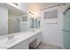 Bright bathroom with double vanity sinks and a glass-enclosed shower at 3956 N 151St Dr, Goodyear, AZ 85395