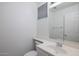 Bright powder room with single sink vanity and a neutral, serene design at 3956 N 151St Dr, Goodyear, AZ 85395