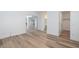 Bedroom featuring hardwood floors and access to an ensuite bathroom and walk-in closet at 3956 N 151St Dr, Goodyear, AZ 85395