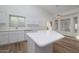 Modern kitchen with white cabinets, an island, and stainless steel appliances at 3956 N 151St Dr, Goodyear, AZ 85395