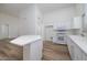 Modern kitchen with white cabinets, an island, and stainless steel appliances at 3956 N 151St Dr, Goodyear, AZ 85395