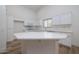 Modern kitchen with white cabinets, an island, and stainless steel appliances at 3956 N 151St Dr, Goodyear, AZ 85395