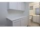Laundry room featuring cabinets, storage and access to a bathroom at 3956 N 151St Dr, Goodyear, AZ 85395
