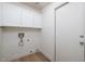 Well-lit laundry room with storage cabinets, utility connections, and vinyl plank flooring at 3956 N 151St Dr, Goodyear, AZ 85395