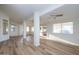 Spacious living room featuring decorative support beams, recessed lighting, and hardwood floors at 3956 N 151St Dr, Goodyear, AZ 85395