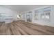 Bright open-concept space with wood-look floors, high ceilings, and abundant natural light at 3956 N 151St Dr, Goodyear, AZ 85395