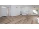 Bright open-concept space with wood-look floors, high ceilings, and abundant natural light at 3956 N 151St Dr, Goodyear, AZ 85395