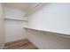 Walk-in closet with shelving and hardwood floors at 3956 N 151St Dr, Goodyear, AZ 85395