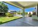 Backyard featuring a covered patio, a pizza oven, a lawn, a hedge, and a swimming pool at 4167 E Sierra Madre Ave, Gilbert, AZ 85296