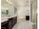 Bright bathroom featuring double sinks, a soaking tub, and a glass-enclosed shower at 4167 E Sierra Madre Ave, Gilbert, AZ 85296