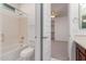 Clean bathroom featuring a tub, toilet, and vanity, conveniently located adjacent to the bedroom at 4167 E Sierra Madre Ave, Gilbert, AZ 85296