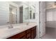 Modern bathroom boasting double sinks, a large mirror, and access to a separate shower and bedroom at 4167 E Sierra Madre Ave, Gilbert, AZ 85296