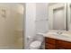 Bathroom featuring a walk-in shower with a glass door and a wooden vanity cabinet with a white countertop at 4167 E Sierra Madre Ave, Gilbert, AZ 85296