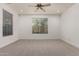 Bedroom featuring neutral carpet, a ceiling fan and two windows offering views of the outdoors at 4167 E Sierra Madre Ave, Gilbert, AZ 85296