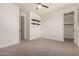 Clean bedroom with a ceiling fan, closet, neutral carpet, and convenient access to adjacent rooms at 4167 E Sierra Madre Ave, Gilbert, AZ 85296