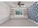 Bedroom with neutral carpet, blue wallpaper, wood floating shelves, built-in benches, and shutters at 4167 E Sierra Madre Ave, Gilbert, AZ 85296
