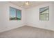 Cozy bedroom with a ceiling fan and two large windows offering ample natural light and outdoor views at 4167 E Sierra Madre Ave, Gilbert, AZ 85296