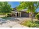 Charming two-story home with brick accents, dark gray garage doors, and lush green grass at 4167 E Sierra Madre Ave, Gilbert, AZ 85296