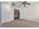 Hallway with neutral carpet and views into a lounge area and a laundry room at 4167 E Sierra Madre Ave, Gilbert, AZ 85296