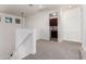 Upstairs hallway with neutral carpet, a staircase with white banisters, and a laundry room at 4167 E Sierra Madre Ave, Gilbert, AZ 85296