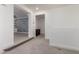 Hallway with neutral carpet and views into a lounge area and a laundry room at 4167 E Sierra Madre Ave, Gilbert, AZ 85296