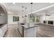 Spacious island kitchen with pendant lighting open to the living area at 4167 E Sierra Madre Ave, Gilbert, AZ 85296