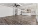 Bright, open-concept living room with gray wood floors and a modern kitchen view at 4167 E Sierra Madre Ave, Gilbert, AZ 85296