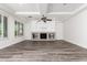 Spacious living room with fireplace, built-in shelving, and tray ceiling at 4167 E Sierra Madre Ave, Gilbert, AZ 85296