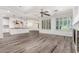 Bright living room featuring wood floors, white walls, and a fireplace at 4167 E Sierra Madre Ave, Gilbert, AZ 85296