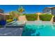 A sparkling blue in-ground pool and spa combination, surrounded by lush landscaping at 4167 E Sierra Madre Ave, Gilbert, AZ 85296