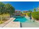 Backyard swimming pool with travertine tile and well-manicured landscaping at 4167 E Sierra Madre Ave, Gilbert, AZ 85296