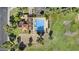 Scenic aerial view of a community pool surrounded by green lawns, trees, and a covered patio area at 4182 W Park Ave, Chandler, AZ 85226