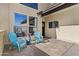 Charming front porch with cozy blue chairs, colorful potted plants, and stylish decor, creating a welcoming entrance at 4182 W Park Ave, Chandler, AZ 85226