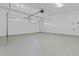 Bright garage with painted walls, epoxy floor and new white garage door at 4182 W Park Ave, Chandler, AZ 85226