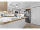 Modern kitchen featuring sleek white cabinetry, stainless steel appliances, and a stylish breakfast bar for casual dining at 4182 W Park Ave, Chandler, AZ 85226