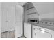 Convenient laundry room with washer, dryer, and additional shelving for storage at 4182 W Park Ave, Chandler, AZ 85226