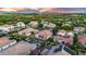 Panoramic aerial shot of a neighborhood highlights homes with pristine pools, landscaping, and mountain views at 4206 E Blue Ridge Pl, Chandler, AZ 85249
