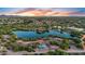 Beautiful aerial shot of a community park with a serene lake and colorful sunset at 4206 E Blue Ridge Pl, Chandler, AZ 85249