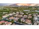 Overhead shot highlights a community with lush surroundings, a peaceful lake, and scenic mountains in the backdrop at 4206 E Blue Ridge Pl, Chandler, AZ 85249