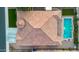 Birds-eye view of the tile roof, green grass and stunning turquoise pool at 4206 E Blue Ridge Pl, Chandler, AZ 85249