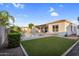 Spacious backyard featuring a pool, green lawn, and covered patio, perfect for outdoor living and entertaining at 4206 E Blue Ridge Pl, Chandler, AZ 85249