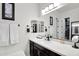 A vanity with white countertop has a double mirror reflecting an open linen closet at 4206 E Blue Ridge Pl, Chandler, AZ 85249