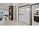 Bathroom with glass enclosed shower, storage shelving, and a view into an adjacent bedroom at 4206 E Blue Ridge Pl, Chandler, AZ 85249