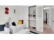 A cozy bedroom features a comfortable couch and an organized closet with built-in shelving at 4206 E Blue Ridge Pl, Chandler, AZ 85249