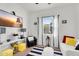 A bright bedroom is decorated with striped rugs, white furniture and colorful accents with a view to the outside at 4206 E Blue Ridge Pl, Chandler, AZ 85249