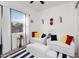 A bright bedroom is decorated with striped rugs, white furniture and colorful accents with a view to the outside at 4206 E Blue Ridge Pl, Chandler, AZ 85249