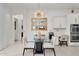 A beautifully lit dining area features a modern glass table, white chairs, and gold chandelier at 4206 E Blue Ridge Pl, Chandler, AZ 85249