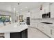 Bright kitchen with white cabinets, island seating, and modern stainless steel appliances at 4206 E Blue Ridge Pl, Chandler, AZ 85249