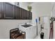 The laundry room has dark brown cabinets over the modern appliances at 4206 E Blue Ridge Pl, Chandler, AZ 85249